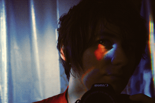 Photo of myself in the mirror with rainbow light on my right eye